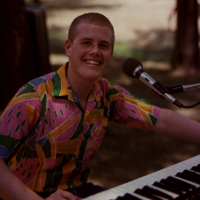 Keyboardist smiling at the camera