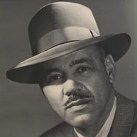 Leon Jordan wearing a fedora and moustache