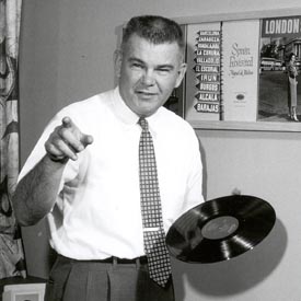 Dave E. Dexter holding a record