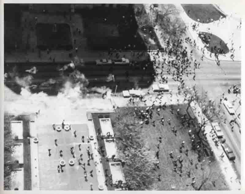 Aerial view of crowds running from tear gas