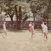 People playing a game of waterballoon toss at picnic