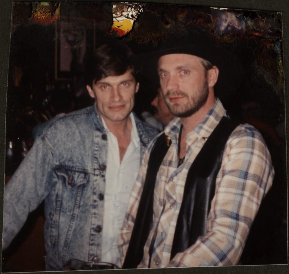 Buddy Taylor and man wearing cowboy hat and vest