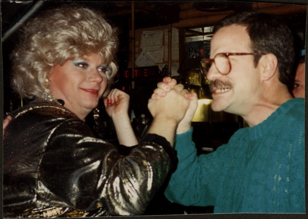 Person arm-wrestling a person in drag