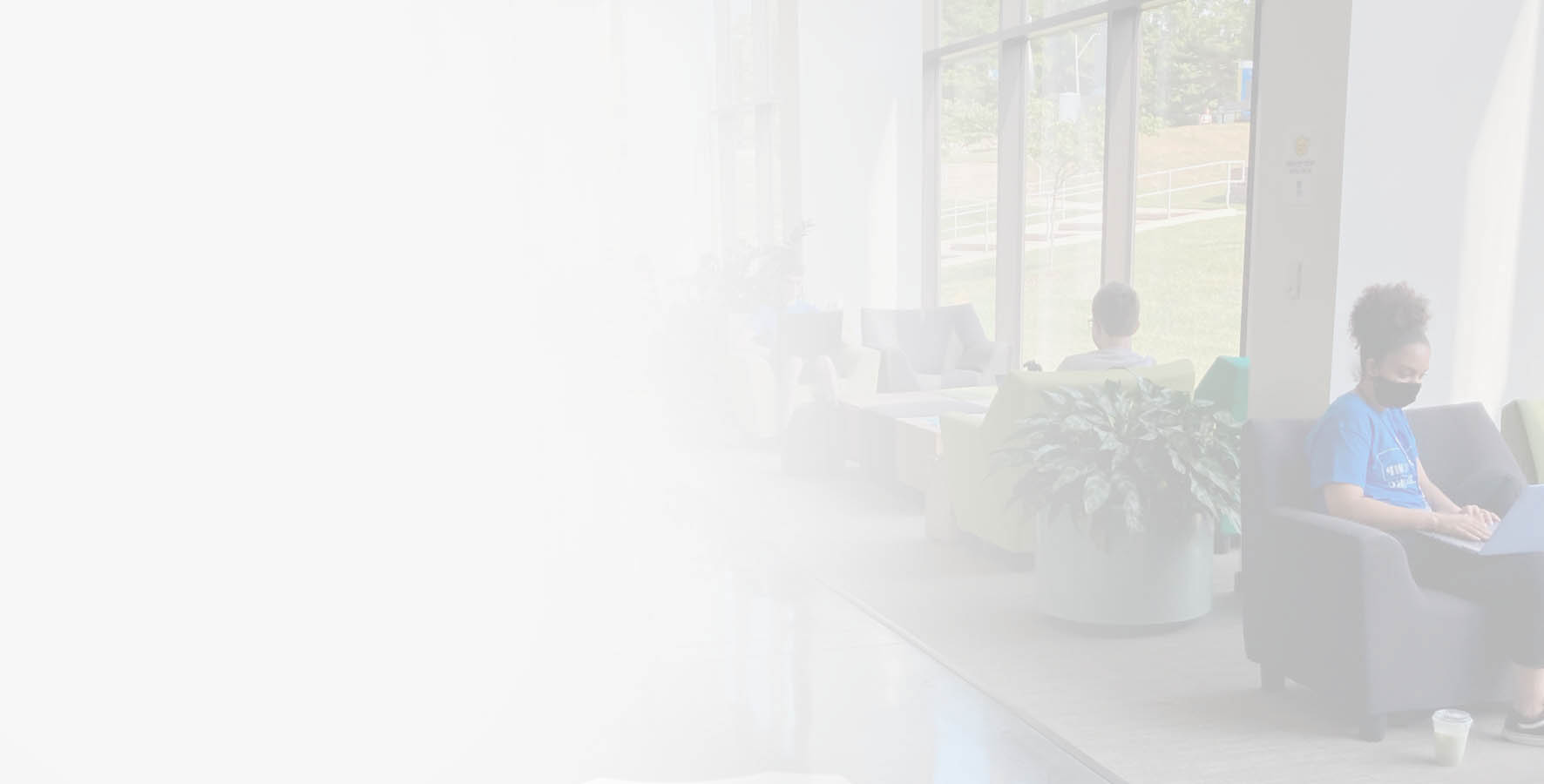 Masked students study in the Miller Nichols Learning Center hallway